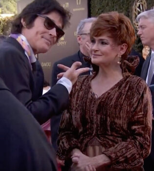Carolyn Hennesy wears Ivey Abitz on the Emmys red carpet whilst interviewing actor Ron Moss