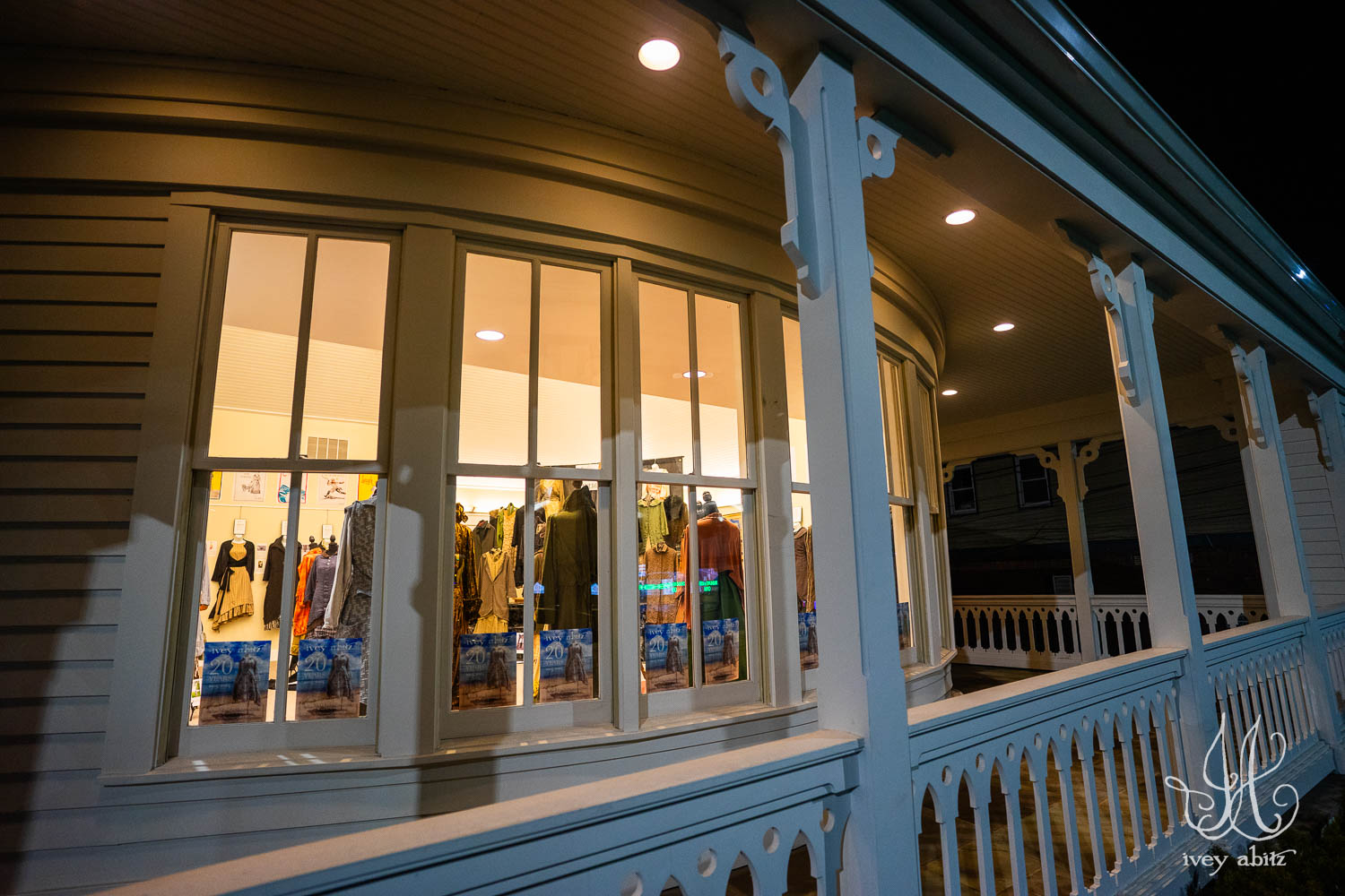 The Ivey Abitz 20 Year Retrospective Exhibit seen through the bay window at the Highland Falls Library at night.