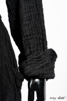 Scattergood Duster Coat in Black Crinkled Washed Linen; Scattergood Frock in Arthurian Green Floral Washed Linen. By Ivey Abitz