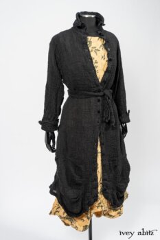 Scattergood Duster Coat in Black Crinkled Washed Linen; Scattergood Frock in Arthurian Green Floral Washed Linen. By Ivey Abitz
