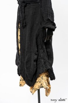 Scattergood Duster Coat in Black Crinkled Washed Linen; Scattergood Frock in Arthurian Green Floral Washed Linen. By Ivey Abitz