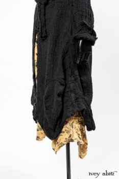 Scattergood Duster Coat in Black Crinkled Washed Linen; Scattergood Frock in Arthurian Green Floral Washed Linen. By Ivey Abitz