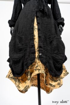 Scattergood Duster Coat in Black Crinkled Washed Linen; Scattergood Frock in Arthurian Green Floral Washed Linen. By Ivey Abitz