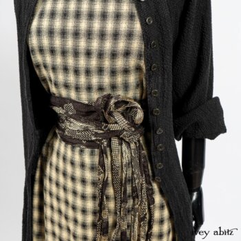 Elsie Duster Coat in Black Puckered Check Weave; Blanchefleur Frock in Black and Natural Plaid Weave; Porte Cochere Sash in Black and Natural Embroidered Floral Weave. By Ivey Abitz