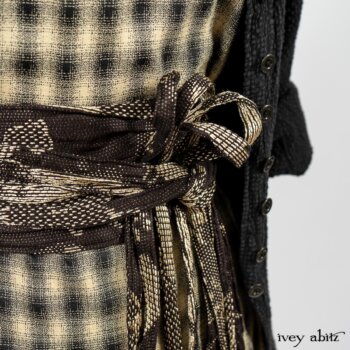 Elsie Duster Coat in Black Puckered Check Weave; Blanchefleur Frock in Black and Natural Plaid Weave; Porte Cochere Sash in Black and Natural Embroidered Floral Weave. By Ivey Abitz