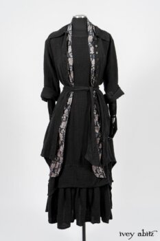 Elsie Duster Coat in Black Puckered Check Weave; Limited Edition Blanchefleur Sash in Wolfie Grey Floral Voile; Blanchefleur Frock in Black Puckered Check Weave. By Ivey Abitz