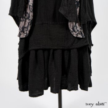 Elsie Duster Coat in Black Puckered Check Weave; Limited Edition Blanchefleur Sash in Wolfie Grey Floral Voile; Blanchefleur Frock in Black Puckered Check Weave. By Ivey Abitz