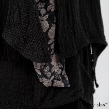 Elsie Duster Coat in Black Puckered Check Weave; Limited Edition Blanchefleur Sash in Wolfie Grey Floral Voile; Blanchefleur Frock in Black Puckered Check Weave. By Ivey Abitz