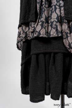 Elsie Duster Coat in Black Puckered Check Weave; Limited Edition Blanchefleur Sash in Wolfie Grey Floral Voile; Wildefield Frock in Wolfie Grey Floral Voile; Blanchefleur Frock in Black Puckered Check Weave. By Ivey Abitz