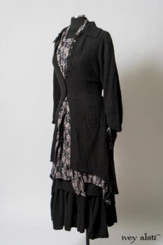 Elsie Duster Coat in Black Puckered Check Weave; Limited Edition Blanchefleur Sash in Wolfie Grey Floral Voile; Wildefield Frock in Wolfie Grey Floral Voile; Blanchefleur Frock in Black Puckered Check Weave. By Ivey Abitz