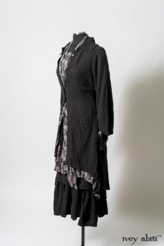 Elsie Duster Coat in Black Puckered Check Weave; Limited Edition Blanchefleur Sash in Wolfie Grey Floral Voile; Wildefield Frock in Wolfie Grey Floral Voile; Blanchefleur Frock in Black Puckered Check Weave. By Ivey Abitz