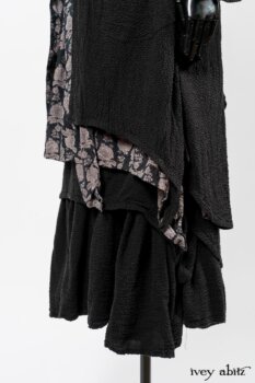 Elsie Duster Coat in Black Puckered Check Weave; Limited Edition Blanchefleur Sash in Wolfie Grey Floral Voile; Wildefield Frock in Wolfie Grey Floral Voile; Blanchefleur Frock in Black Puckered Check Weave. By Ivey Abitz