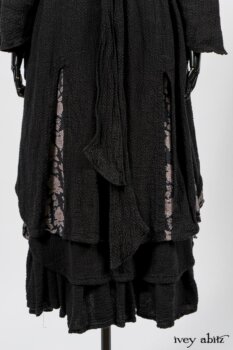 Elsie Duster Coat in Black Puckered Check Weave; Limited Edition Blanchefleur Sash in Wolfie Grey Floral Voile; Wildefield Frock in Wolfie Grey Floral Voile; Blanchefleur Frock in Black Puckered Check Weave. By Ivey Abitz