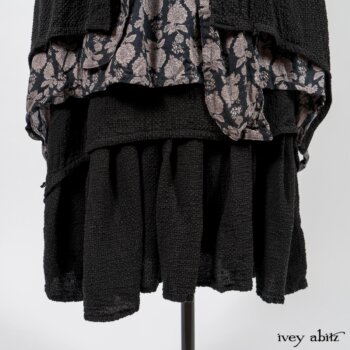 Elsie Duster Coat in Black Puckered Check Weave; Limited Edition Blanchefleur Sash in Wolfie Grey Floral Voile; Wildefield Frock in Wolfie Grey Floral Voile; Blanchefleur Frock in Black Puckered Check Weave. By Ivey Abitz
