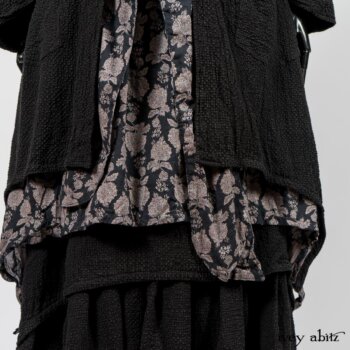 Elsie Duster Coat in Black Puckered Check Weave; Limited Edition Blanchefleur Sash in Wolfie Grey Floral Voile; Wildefield Frock in Wolfie Grey Floral Voile; Blanchefleur Frock in Black Puckered Check Weave. By Ivey Abitz