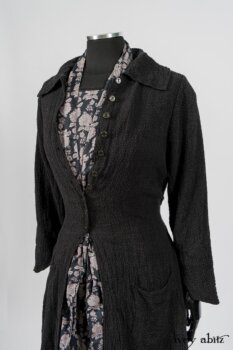 Elsie Duster Coat in Black Puckered Check Weave; Limited Edition Blanchefleur Sash in Wolfie Grey Floral Voile; Wildefield Frock in Wolfie Grey Floral Voile; Blanchefleur Frock in Black Puckered Check Weave. By Ivey Abitz