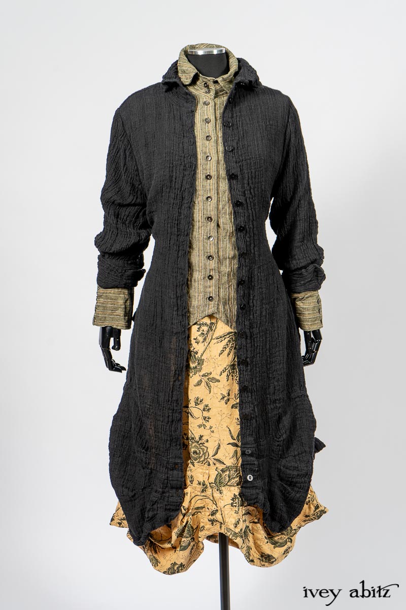 Scattergood Duster Coat in Black Crinkled Washed Linen; Scattergood Frock in Arthurian Green Floral Washed Linen; Truitt Shirt in Peace and Civility Stripe Linen. By Ivey Abitz