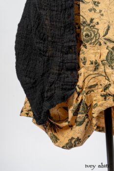 Scattergood Duster Coat in Black Crinkled Washed Linen; Scattergood Frock in Arthurian Green Floral Washed Linen; Truitt Shirt in Peace and Civility Stripe Linen. By Ivey Abitz