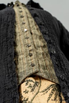 Scattergood Duster Coat in Black Crinkled Washed Linen; Scattergood Frock in Arthurian Green Floral Washed Linen; Truitt Shirt in Peace and Civility Stripe Linen. By Ivey Abitz