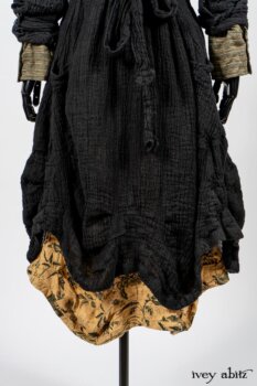 Scattergood Duster Coat in Black Crinkled Washed Linen; Scattergood Frock in Arthurian Green Floral Washed Linen; Truitt Shirt in Peace and Civility Stripe Linen. By Ivey Abitz