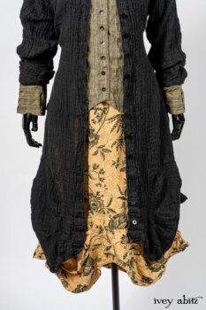Scattergood Duster Coat in Black Crinkled Washed Linen; Scattergood Frock in Arthurian Green Floral Washed Linen; Truitt Shirt in Peace and Civility Stripe Linen. By Ivey Abitz