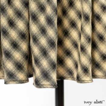 Clotaire Sash in Black and Natural Embroidered Floral Weave; Blanchefleur Frock in Black and Natural Plaid Weave; Elsie Duster Coat in Black Puckered Check Weave. By Ivey Abitz