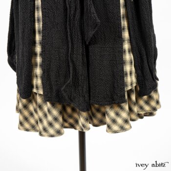 Clotaire Sash in Black and Natural Embroidered Floral Weave; Blanchefleur Frock in Black and Natural Plaid Weave; Elsie Duster Coat in Black Puckered Check Weave. By Ivey Abitz