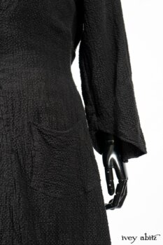 Clotaire Sash in Black and Natural Embroidered Floral Weave; Blanchefleur Frock in Black and Natural Plaid Weave; Elsie Duster Coat in Black Puckered Check Weave. By Ivey Abitz
