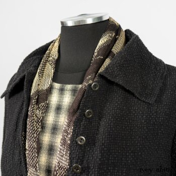 Clotaire Sash in Black and Natural Embroidered Floral Weave; Blanchefleur Frock in Black and Natural Plaid Weave; Elsie Duster Coat in Black Puckered Check Weave. By Ivey Abitz