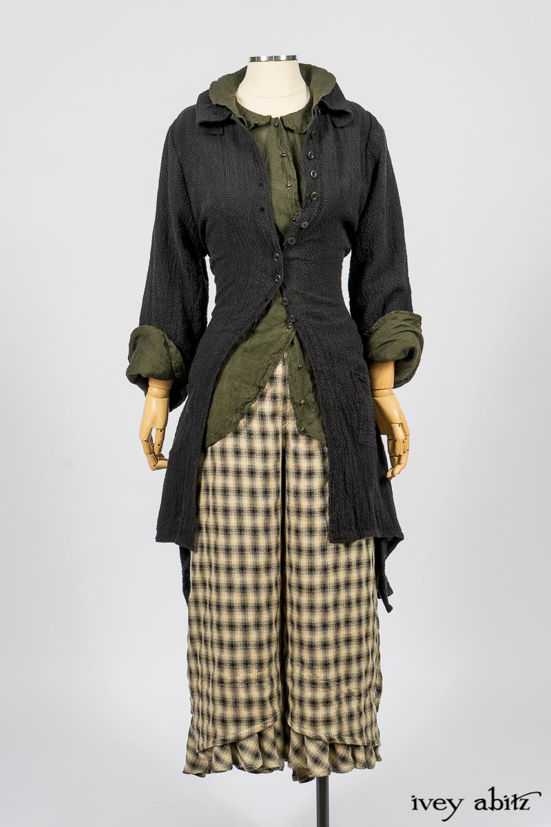 Elsie Duster Coat in Black Puckered Check Weave; Limited Edition Arthur Hill Shirt in Arthurian Green Cotton Voile; Blanchefleur Trousers in Black and Natural Plaid Weave. By Ivey Abitz
