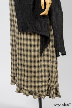 Elsie Duster Coat in Black Puckered Check Weave; Limited Edition Arthur Hill Shirt in Arthurian Green Cotton Voile; Blanchefleur Trousers in Black and Natural Plaid Weave. By Ivey Abitz
