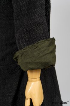 Elsie Duster Coat in Black Puckered Check Weave; Limited Edition Arthur Hill Shirt in Arthurian Green Cotton Voile; Blanchefleur Trousers in Black and Natural Plaid Weave. By Ivey Abitz