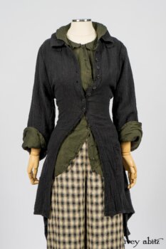 Elsie Duster Coat in Black Puckered Check Weave; Limited Edition Arthur Hill Shirt in Arthurian Green Cotton Voile; Blanchefleur Trousers in Black and Natural Plaid Weave. By Ivey Abitz