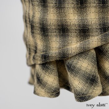Elsie Duster Coat in Black Puckered Check Weave; Limited Edition Arthur Hill Shirt in Arthurian Green Cotton Voile; Blanchefleur Trousers in Black and Natural Plaid Weave. By Ivey Abitz