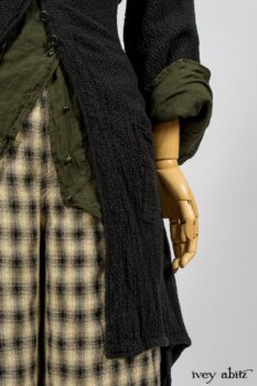 Elsie Duster Coat in Black Puckered Check Weave; Limited Edition Arthur Hill Shirt in Arthurian Green Cotton Voile; Blanchefleur Trousers in Black and Natural Plaid Weave. By Ivey Abitz