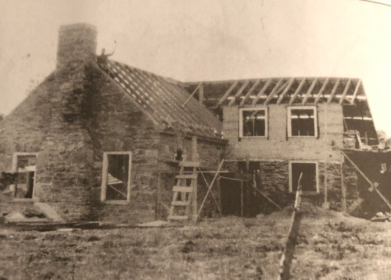 Stone Cottage's walls are finished and roof is being built. Circa 1925. Photograph courtesy National Park Service.