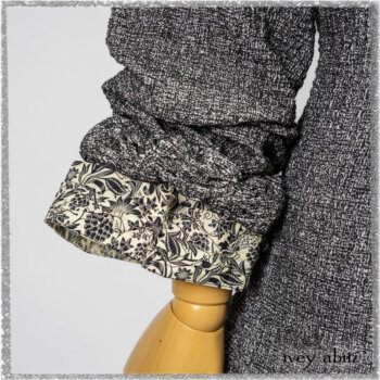 Bartholomew Duster Coat in Black White Painted Puckery Weave; Clotaire Sash in Ethereal Cream and Black Fleur Stretch Cotton; Tollie Dress in Ethereal Cream and Black Fleur Stretch Cotton; Mewland Skirt in Black Washed Crinkled Linen. Ivey Abitz bespoke clothing.