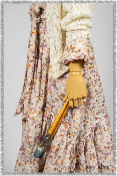 Elliot Jacket in Ethereal Cream Floral Knit; Fairholme Dress in Ethereal Floral Cotton Voile; Fairholme Sash in Ethereal Floral Cotton Voile; Fairholme Frock in Plum Tree Wispy Plaid Cotton. Ivey Abitz bespoke clothing.