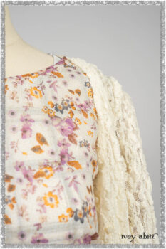 Elliot Jacket in Ethereal Cream Floral Knit; Fairholme Dress in Ethereal Floral Cotton Voile; Fairholme Sash in Ethereal Floral Cotton Voile; Fairholme Frock in Plum Tree Wispy Plaid Cotton. Ivey Abitz bespoke clothing.