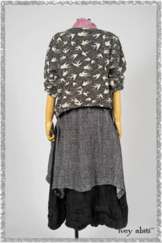 Elliot Jacket in Beacon Flora and Fauna Knit; Bramley Overlay in Black White Painted Puckery Weave; Clotaire Sash in Red Sky at Night Yarn Dyed Weave; Mewland Skirt in Black Washed Crinkled Linen. Ivey Abitz bespoke clothing.