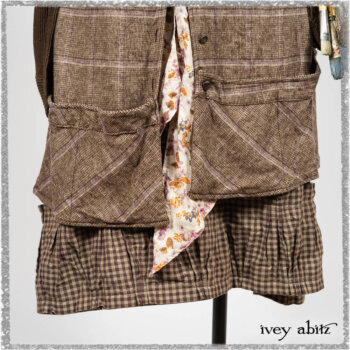 Porte Cochere Shirt Jacket in Earthen Ribbed Weave; Fairholme Sash in Ethereal Floral Cotton Voile; Porte Cochere Frock in Earthen and Plum Stretch Plaid; Gabled Frock in Plum Tree and Woodlawn Check Cotton. Ivey Abitz bespoke clothing.