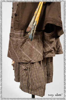 Porte Cochere Shirt Jacket in Earthen Ribbed Weave; Fairholme Sash in Ethereal Floral Cotton Voile; Porte Cochere Frock in Earthen and Plum Stretch Plaid; Gabled Frock in Plum Tree and Woodlawn Check Cotton. Ivey Abitz bespoke clothing.