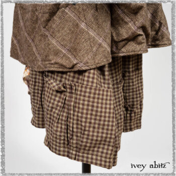 Porte Cochere Shirt Jacket in Earthen Ribbed Weave; Fairholme Sash in Ethereal Floral Cotton Voile; Porte Cochere Frock in Earthen and Plum Stretch Plaid; Gabled Frock in Plum Tree and Woodlawn Check Cotton. Ivey Abitz bespoke clothing.