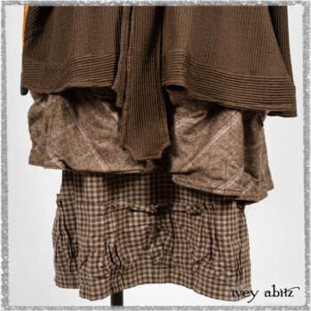 Porte Cochere Shirt Jacket in Earthen Ribbed Weave; Fairholme Sash in Ethereal Floral Cotton Voile; Porte Cochere Frock in Earthen and Plum Stretch Plaid; Gabled Frock in Plum Tree and Woodlawn Check Cotton. Ivey Abitz bespoke clothing.