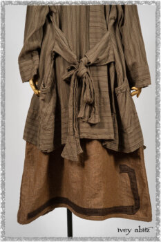 Saint Ans Frock in Chestnut Tree Wondrous Washed Linen with sculptural details in rare weaves; Hudson Duster Coat in Earthen Embroidered Stripe Gauze. Ivey Abitz bespoke clothing.