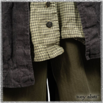 Chevallier Duster Coat in Anchor Grey Wondrous Washed Linen; Chevallier Shirt in Seagrass Petite Check Linen; Chevallier Trousers in Seagrass Herringbone Twill with contrasting lacing to match shirt; Clotaire Sash in Pointillism Silk Chiffon. Ivey Abitz bespoke clothing.