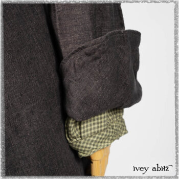 Chevallier Duster Coat in Anchor Grey Wondrous Washed Linen; Chevallier Shirt in Seagrass Petite Check Linen; Chevallier Trousers in Seagrass Herringbone Twill with contrasting lacing to match shirt; Clotaire Sash in Pointillism Silk Chiffon. Ivey Abitz bespoke clothing.