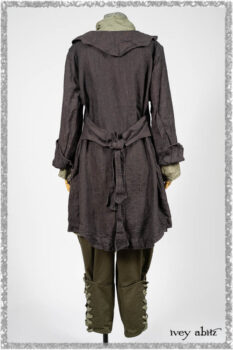Chevallier Duster Coat in Anchor Grey Wondrous Washed Linen; Chevallier Shirt in Seagrass Petite Check Linen; Chevallier Trousers in Seagrass Herringbone Twill with contrasting lacing to match shirt; Clotaire Sash in Pointillism Silk Chiffon. Ivey Abitz bespoke clothing.