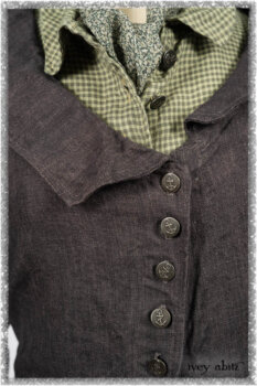 Chevallier Duster Coat in Anchor Grey Wondrous Washed Linen; Chevallier Shirt in Seagrass Petite Check Linen; Chevallier Trousers in Seagrass Herringbone Twill with contrasting lacing to match shirt; Clotaire Sash in Pointillism Silk Chiffon. Ivey Abitz bespoke clothing.