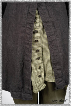Chevallier Duster Coat in Anchor Grey Wondrous Washed Linen; Chevallier Shirt in Seagrass Petite Check Linen; Chevallier Trousers in Seagrass Herringbone Twill with contrasting lacing to match shirt; Clotaire Sash in Pointillism Silk Chiffon. Ivey Abitz bespoke clothing.
